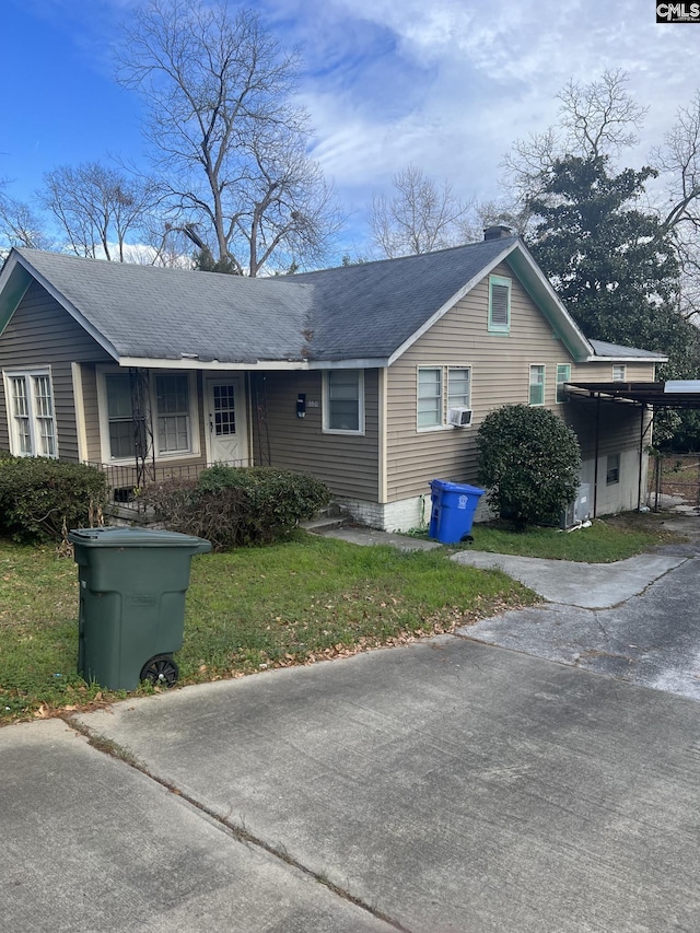 single story home featuring a carport and a front lawn