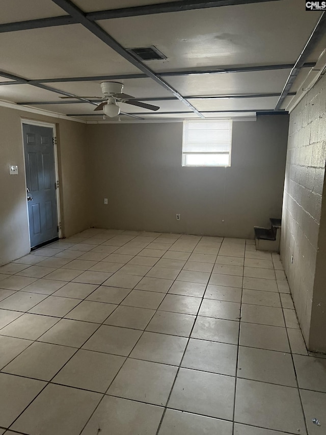 tiled spare room featuring ceiling fan