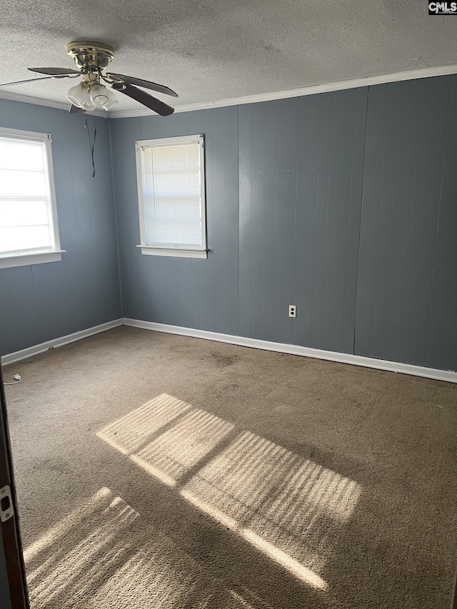 carpeted empty room featuring a textured ceiling and ceiling fan