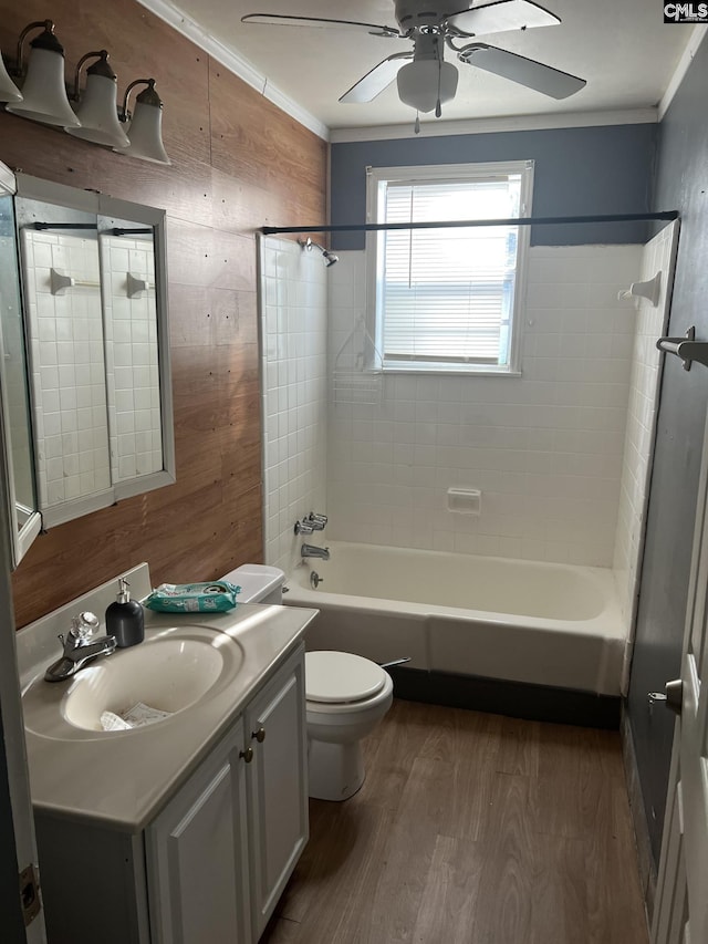 full bathroom featuring tiled shower / bath combo, crown molding, hardwood / wood-style floors, and vanity