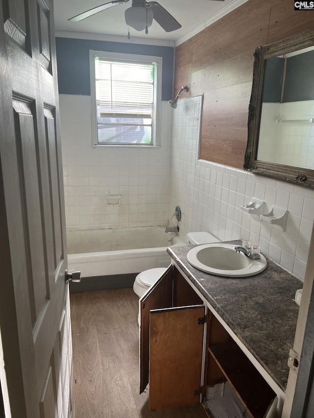 full bathroom featuring vanity, ceiling fan, tiled shower / bath, hardwood / wood-style floors, and toilet