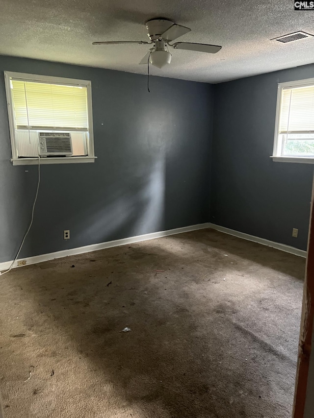 carpeted spare room with a textured ceiling, ceiling fan, and cooling unit