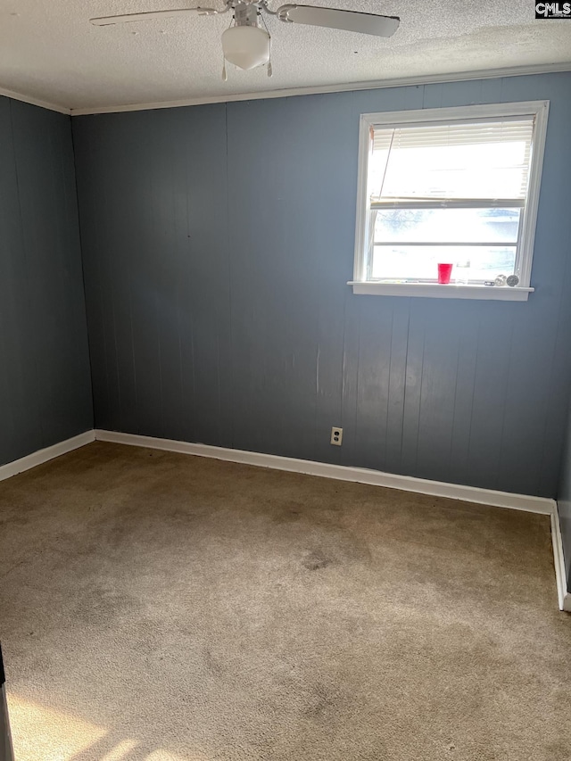 empty room featuring a textured ceiling, carpet, and ceiling fan