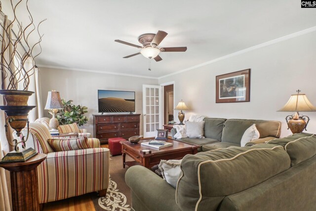 living area featuring ornamental molding, a ceiling fan, and wood finished floors