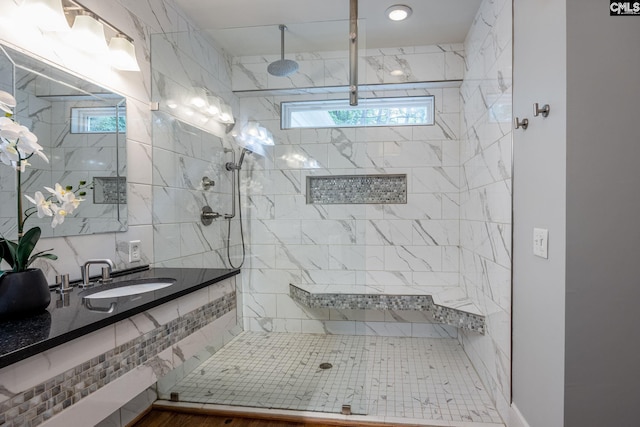 bathroom featuring wood-type flooring, a shower with door, plenty of natural light, and vanity