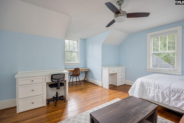 bedroom featuring ceiling fan, hardwood / wood-style flooring, and vaulted ceiling