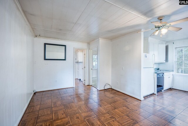 spare room with ceiling fan and dark parquet flooring