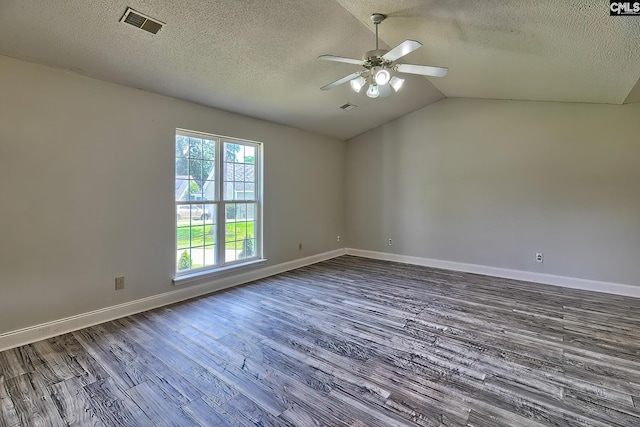 empty room with ceiling fan, vaulted ceiling, a textured ceiling, and hardwood / wood-style floors