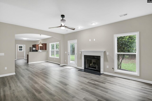 unfurnished living room with hardwood / wood-style floors and ceiling fan