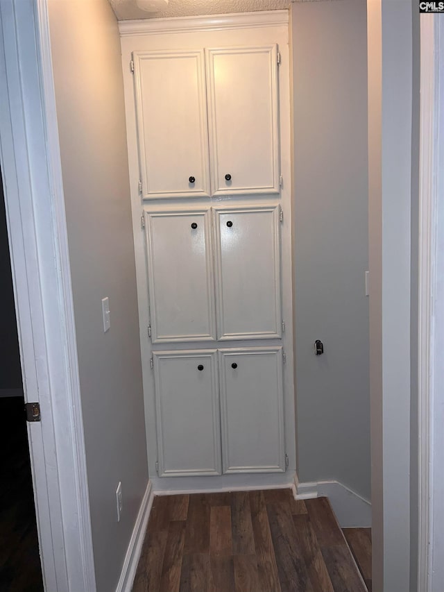 interior space featuring wood finished floors and baseboards