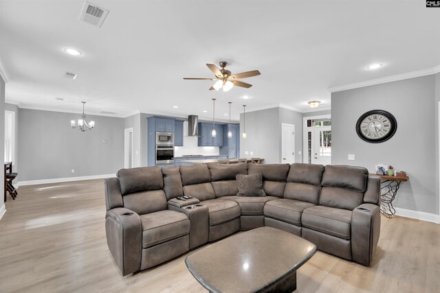 living room featuring ceiling fan with notable chandelier, ornamental molding, and light hardwood / wood-style floors