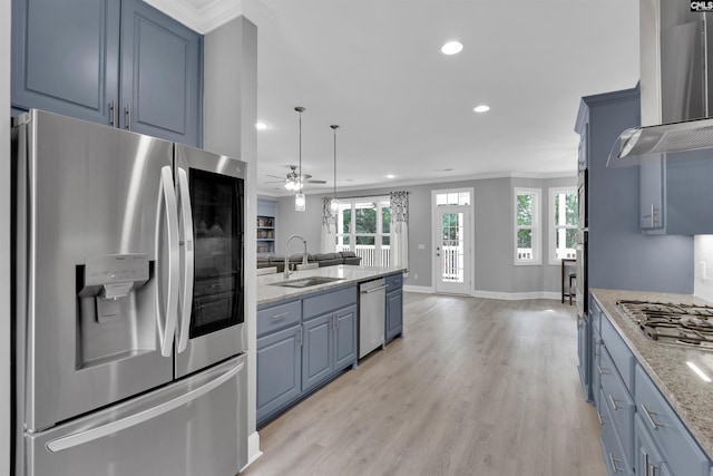 kitchen featuring stainless steel appliances, light hardwood / wood-style floors, ceiling fan, sink, and wall chimney exhaust hood