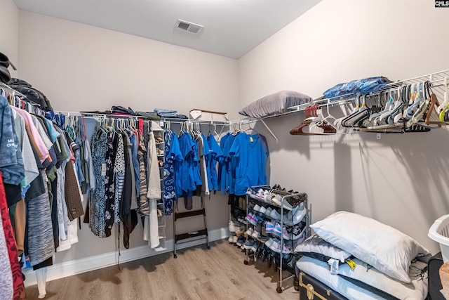 spacious closet featuring hardwood / wood-style floors