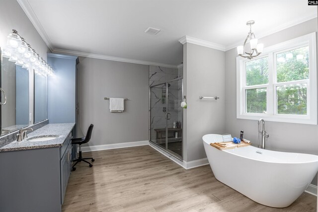 bathroom featuring shower with separate bathtub, hardwood / wood-style flooring, vanity, and ornamental molding