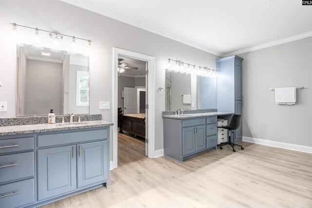 bathroom with ceiling fan, dual vanity, crown molding, and hardwood / wood-style flooring