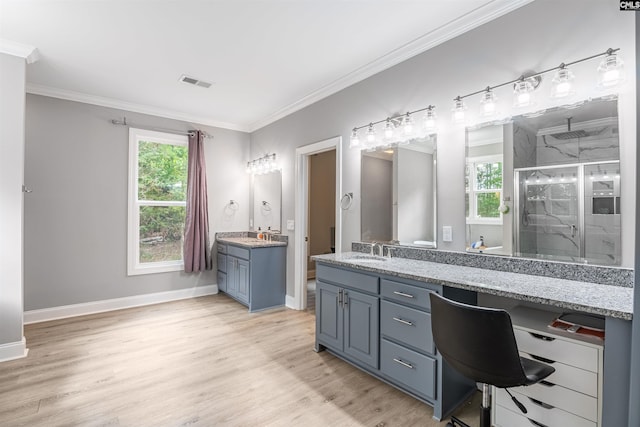 bathroom featuring double vanity, an enclosed shower, ornamental molding, and hardwood / wood-style flooring