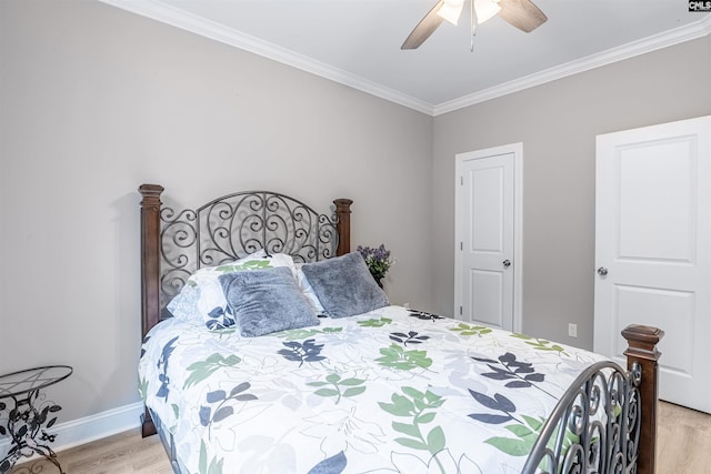 bedroom featuring ceiling fan, crown molding, and light wood-type flooring