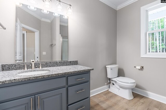 bathroom featuring crown molding, toilet, vanity, and hardwood / wood-style flooring