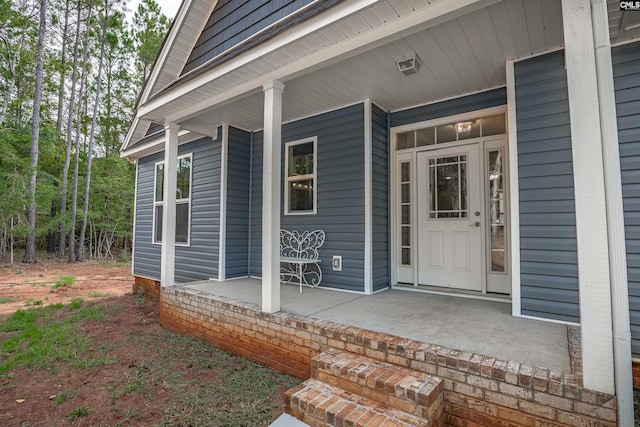 entrance to property featuring covered porch