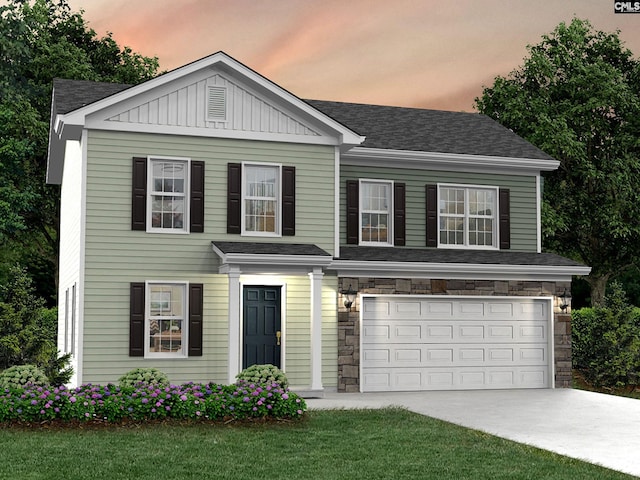 view of front facade featuring a lawn and a garage