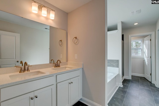 bathroom with tile patterned floors, double vanity, and a bathtub