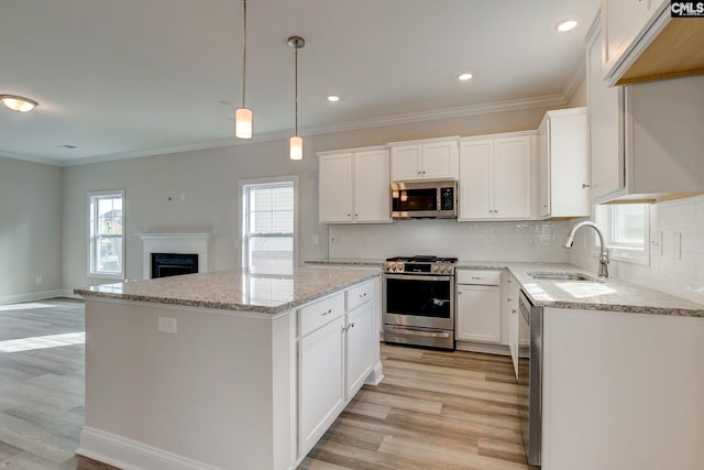 kitchen featuring sink, white cabinetry, light hardwood / wood-style floors, and stainless steel appliances