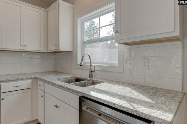 kitchen with sink, decorative backsplash, light stone countertops, dishwasher, and white cabinetry