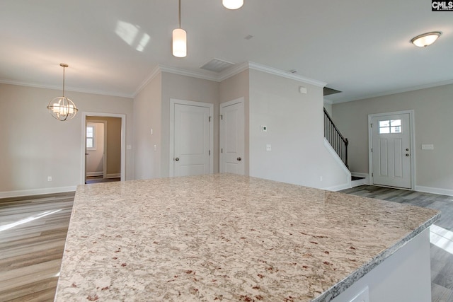 kitchen with light hardwood / wood-style flooring, a healthy amount of sunlight, and hanging light fixtures