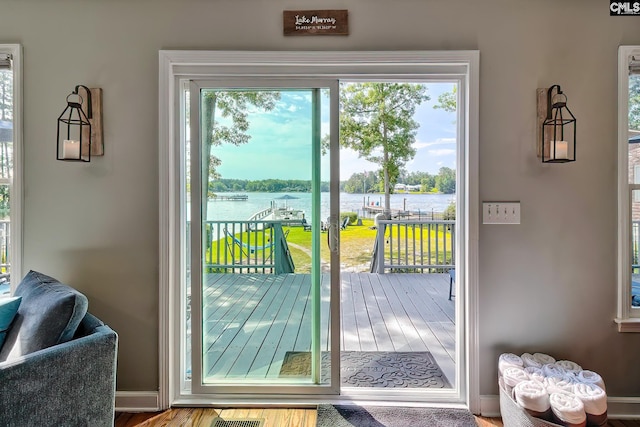 doorway to outside featuring hardwood / wood-style flooring, plenty of natural light, and a water view