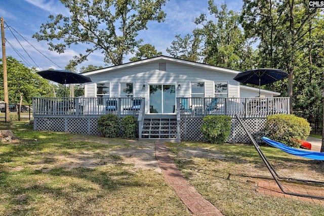 view of front of property featuring a front lawn and a deck