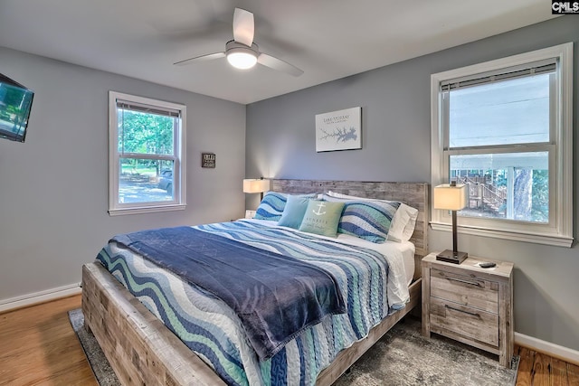 bedroom featuring ceiling fan and dark wood-type flooring