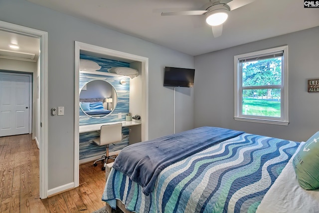 bedroom with ceiling fan and hardwood / wood-style flooring