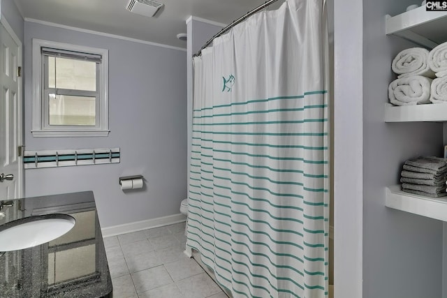 bathroom featuring crown molding, tile patterned flooring, and vanity