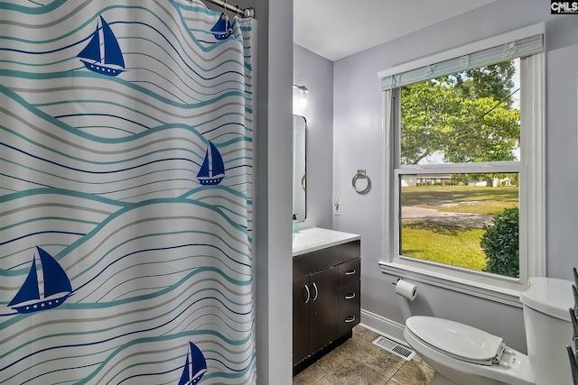 bathroom featuring tile patterned flooring, vanity, and toilet