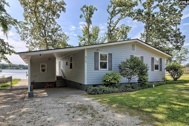 view of front of house with a front lawn and a carport