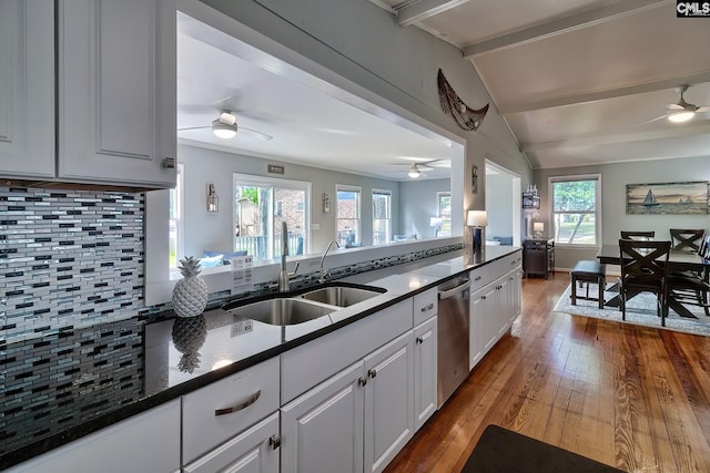 kitchen with backsplash, light hardwood / wood-style flooring, ceiling fan, and plenty of natural light