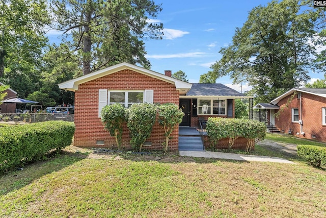 bungalow-style house with a front yard and a porch