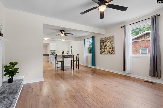 interior space with ceiling fan and light hardwood / wood-style floors