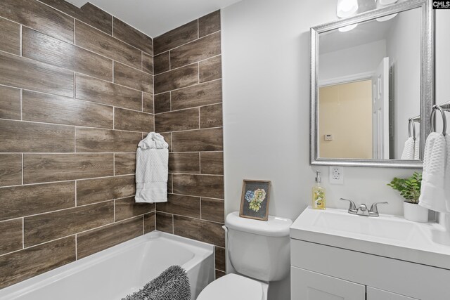 full bathroom with vanity, tiled shower / bath combo, and toilet