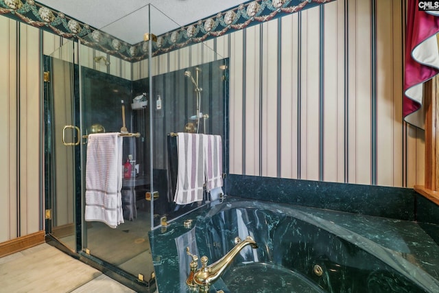 bathroom with a whirlpool tub, a stall shower, wood finished floors, and wallpapered walls