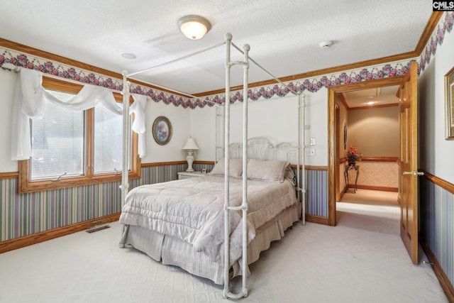 bedroom with wallpapered walls, visible vents, carpet flooring, and wainscoting