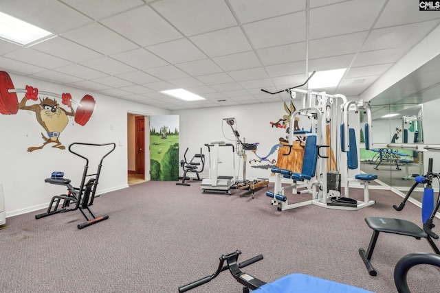 exercise room with a paneled ceiling and baseboards