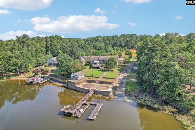 drone / aerial view featuring a water view and a view of trees