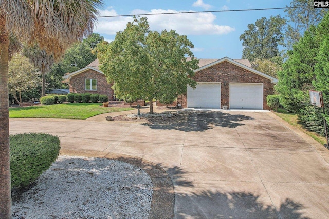 view of front of home with an attached garage, concrete driveway, brick siding, and a front yard