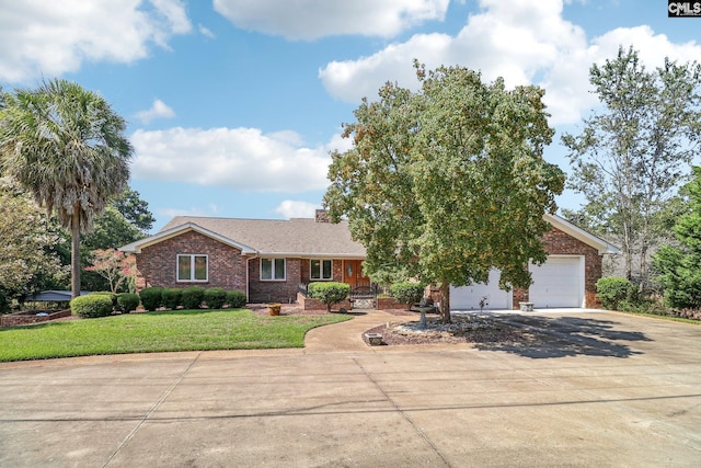 view of front of property featuring a garage, a front lawn, concrete driveway, and brick siding