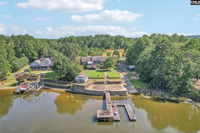 drone / aerial view with a water view and a forest view