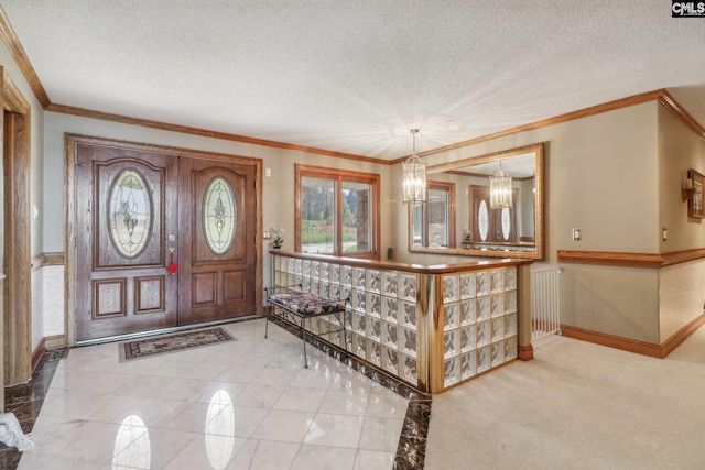 foyer entrance with a chandelier, a textured ceiling, and crown molding