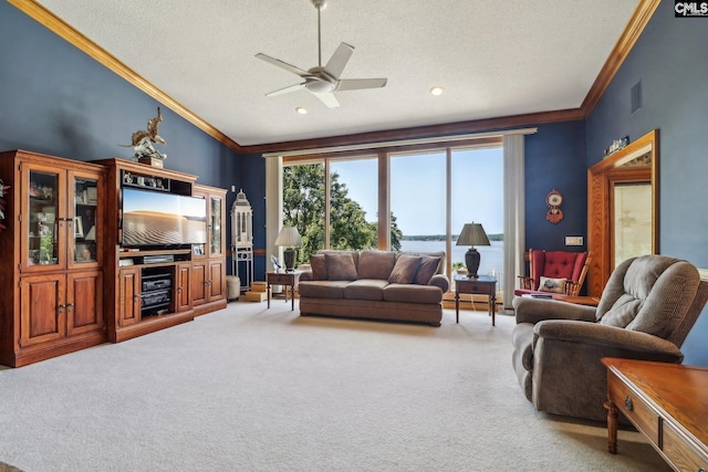 living area with visible vents, ceiling fan, ornamental molding, vaulted ceiling, and carpet floors