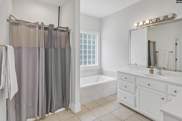 bathroom with a garden tub, tile patterned flooring, and vanity