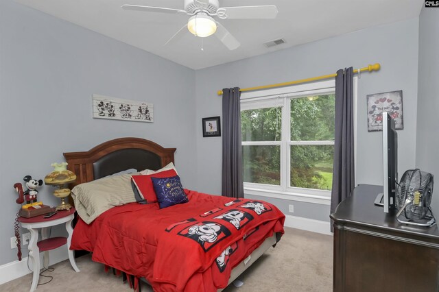 bedroom with light colored carpet, visible vents, a ceiling fan, and baseboards